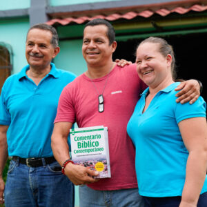 Pastor Gerard holding the Latin America Bible Commentary.